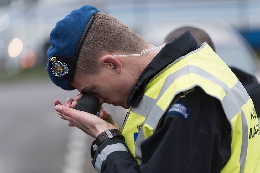 Kmar controleert document met een loep