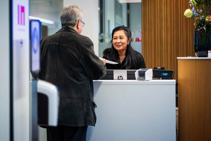 Een baliemedewerker bij het expat centrum INAmsterdam